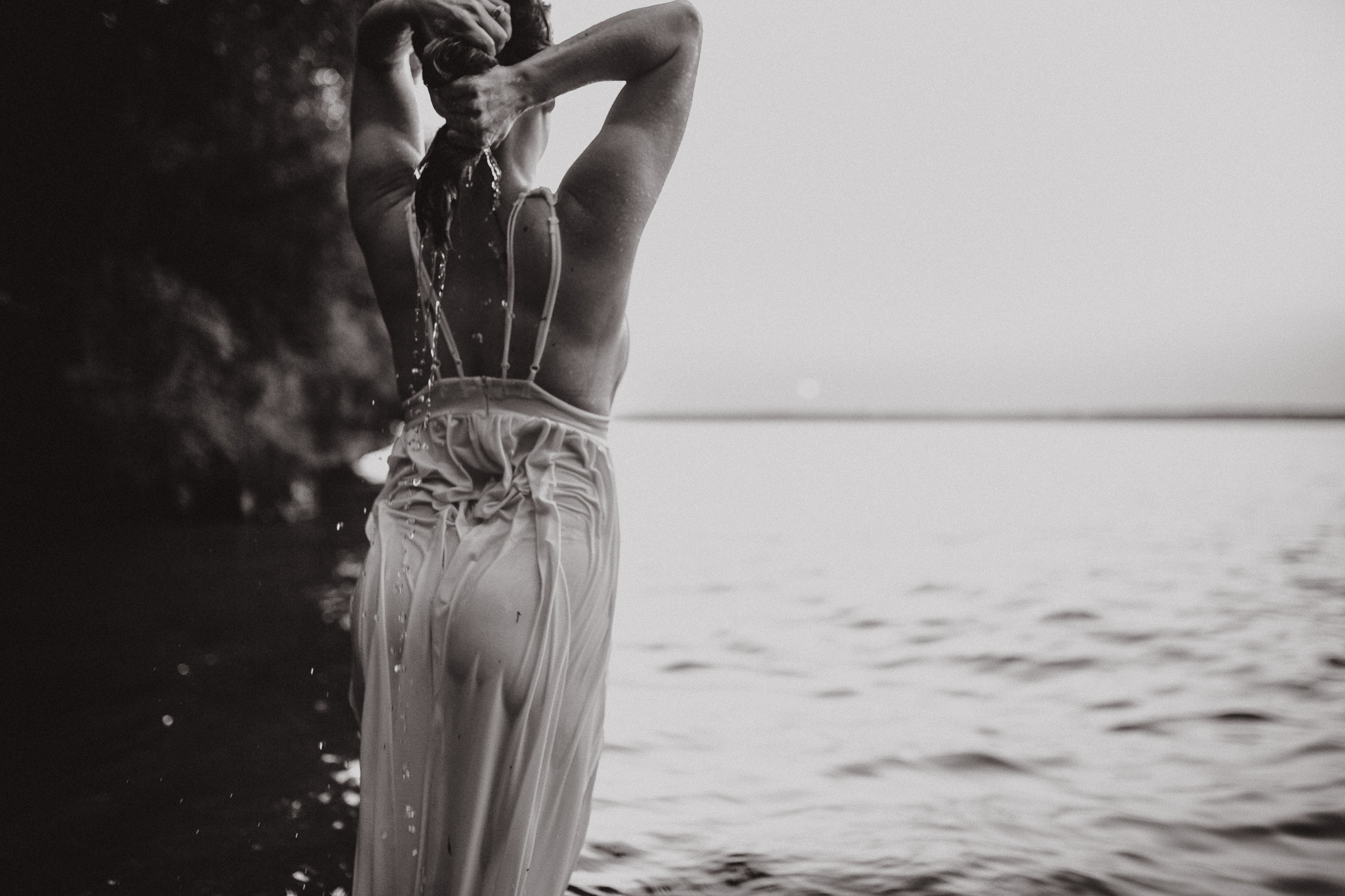 Captivating woman in an intimate lake session during a summer sunset.